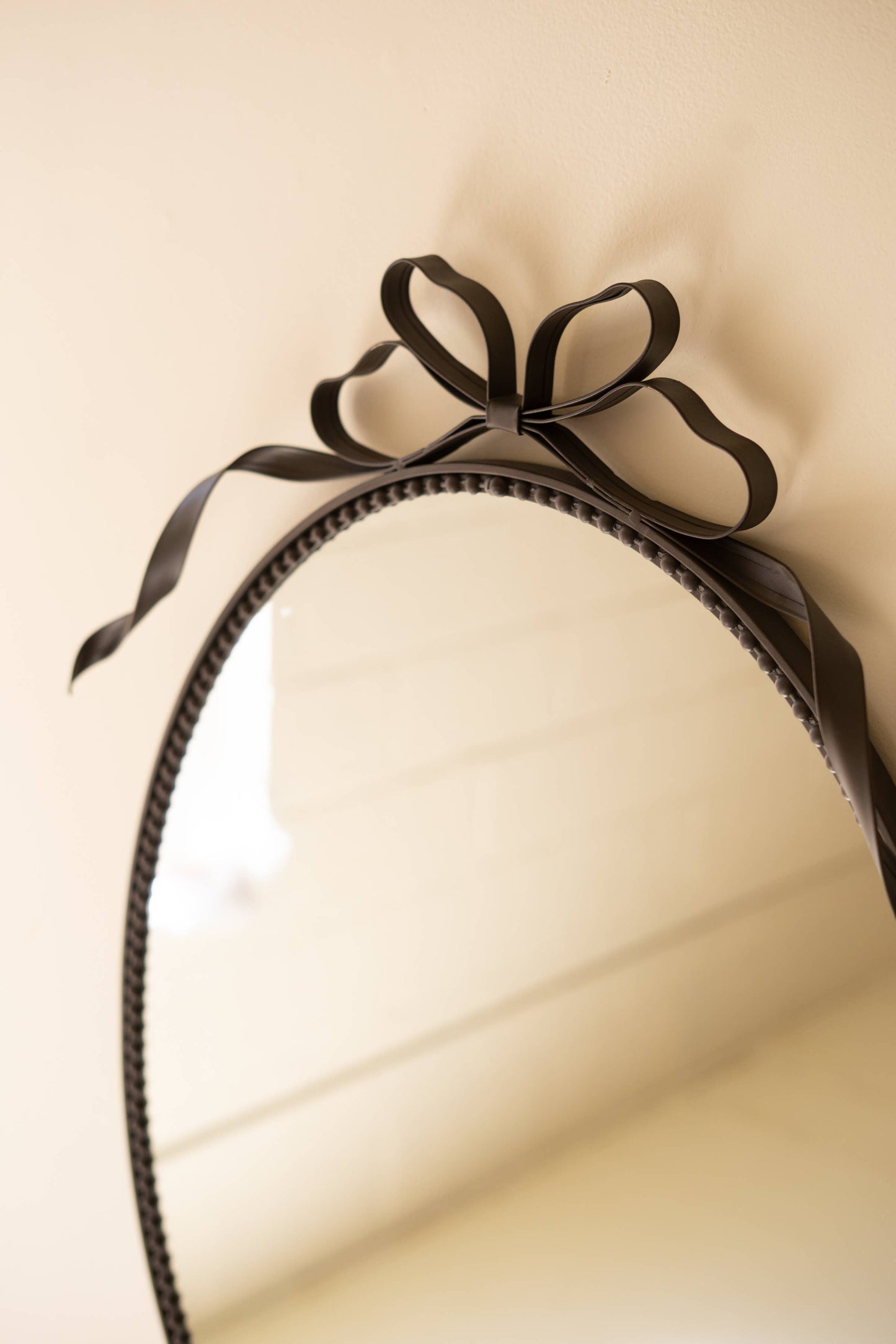 METAL FRAMED OVAL MIRROR - BOW DETAIL