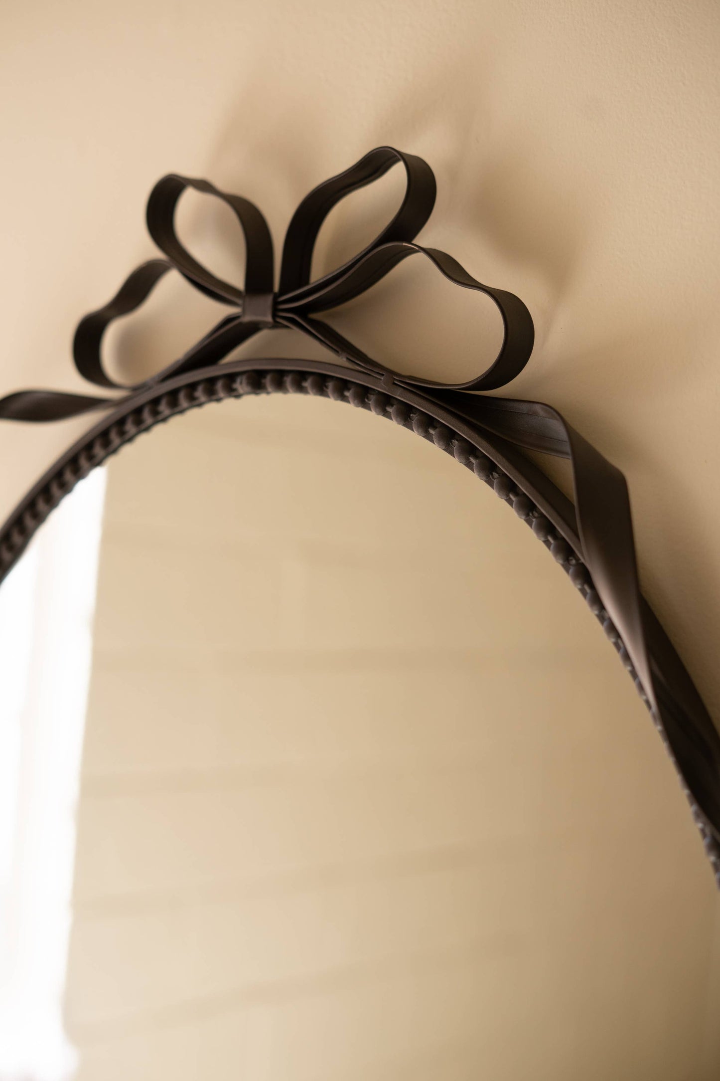 METAL FRAMED OVAL MIRROR - BOW DETAIL